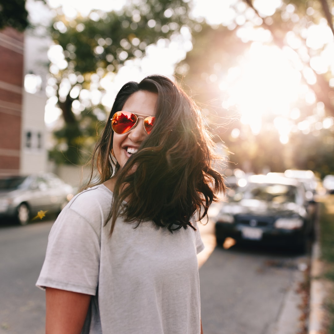 Fall is here by Boat Brands woman wearing white T-shirt smiling