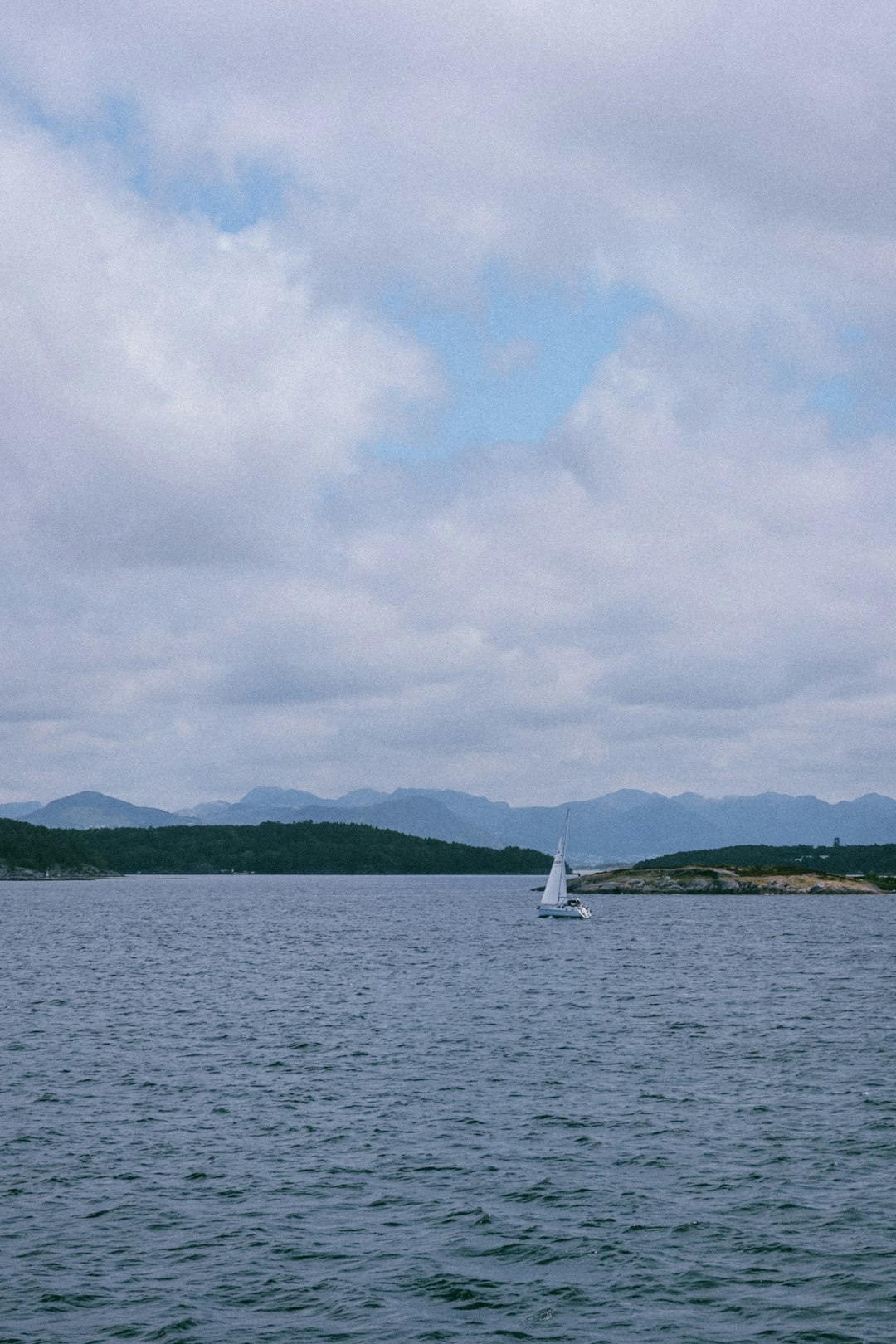 A sailboat in the middle of a large body of water